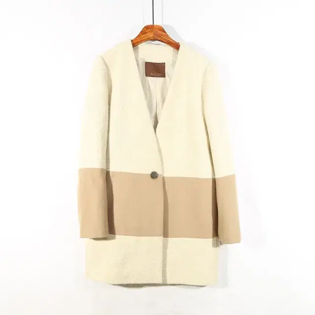 A BY-JAE Coat with zipper sleeve detail and color-coordinated details