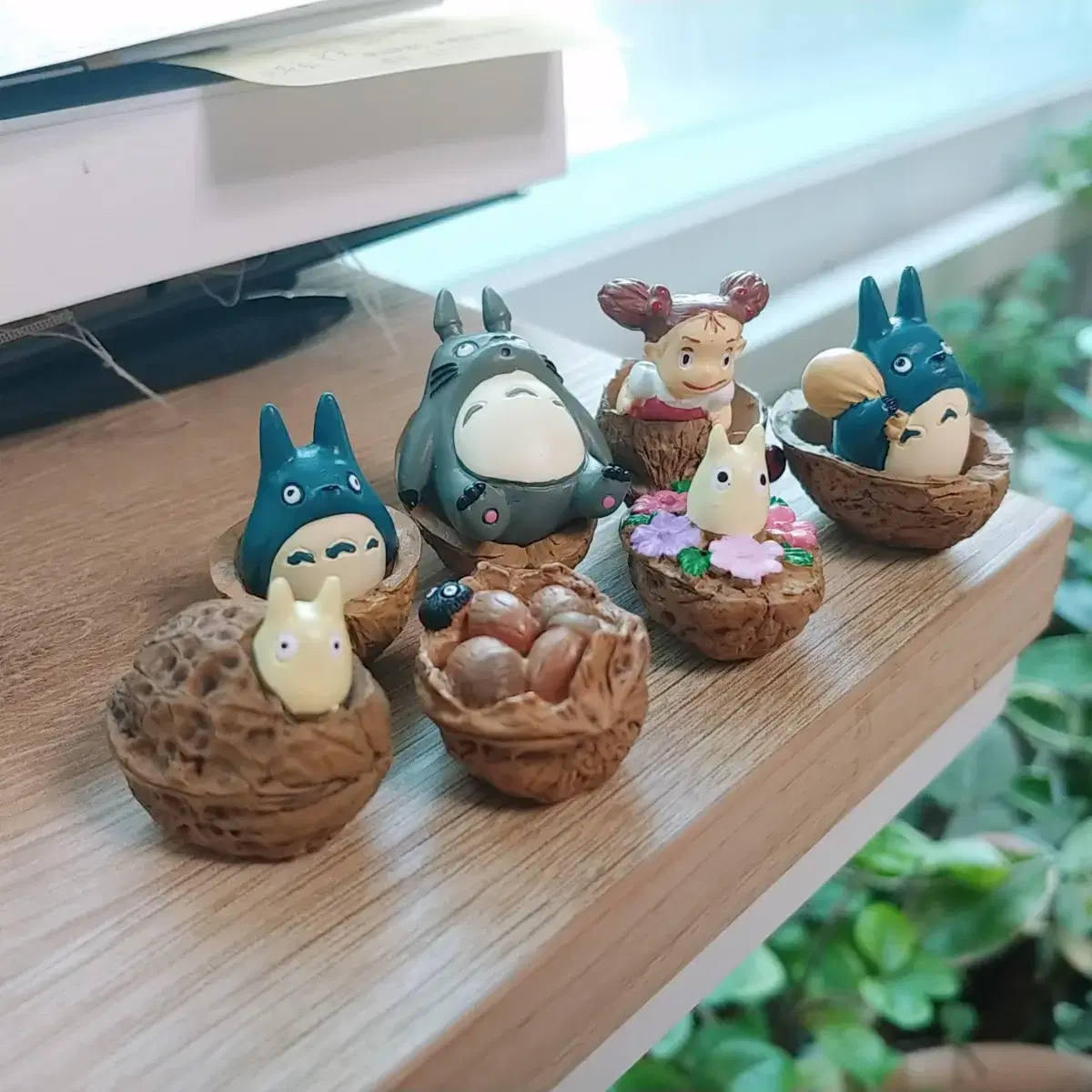 A Totoro figure inside a walnut