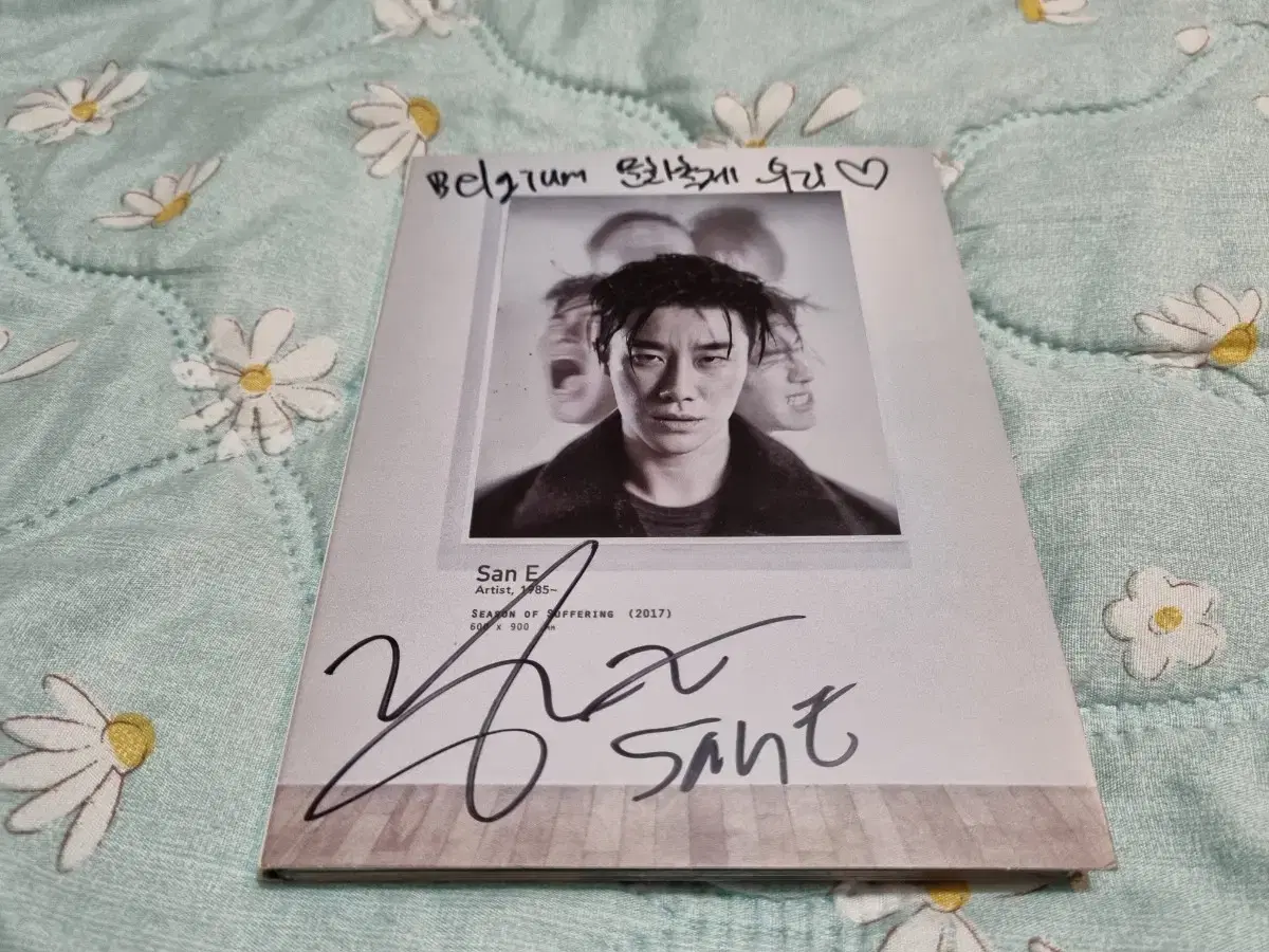 San is selling a non-sale signed album.