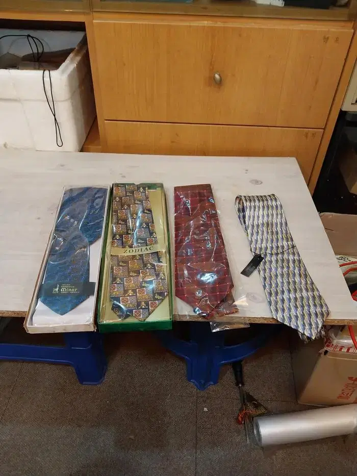 Three unsealed silk ties and more.