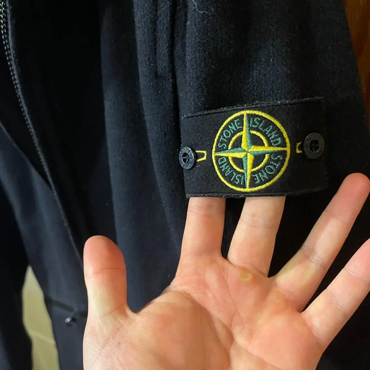 The Stone Island Wool Hooded Coat is available at sell.