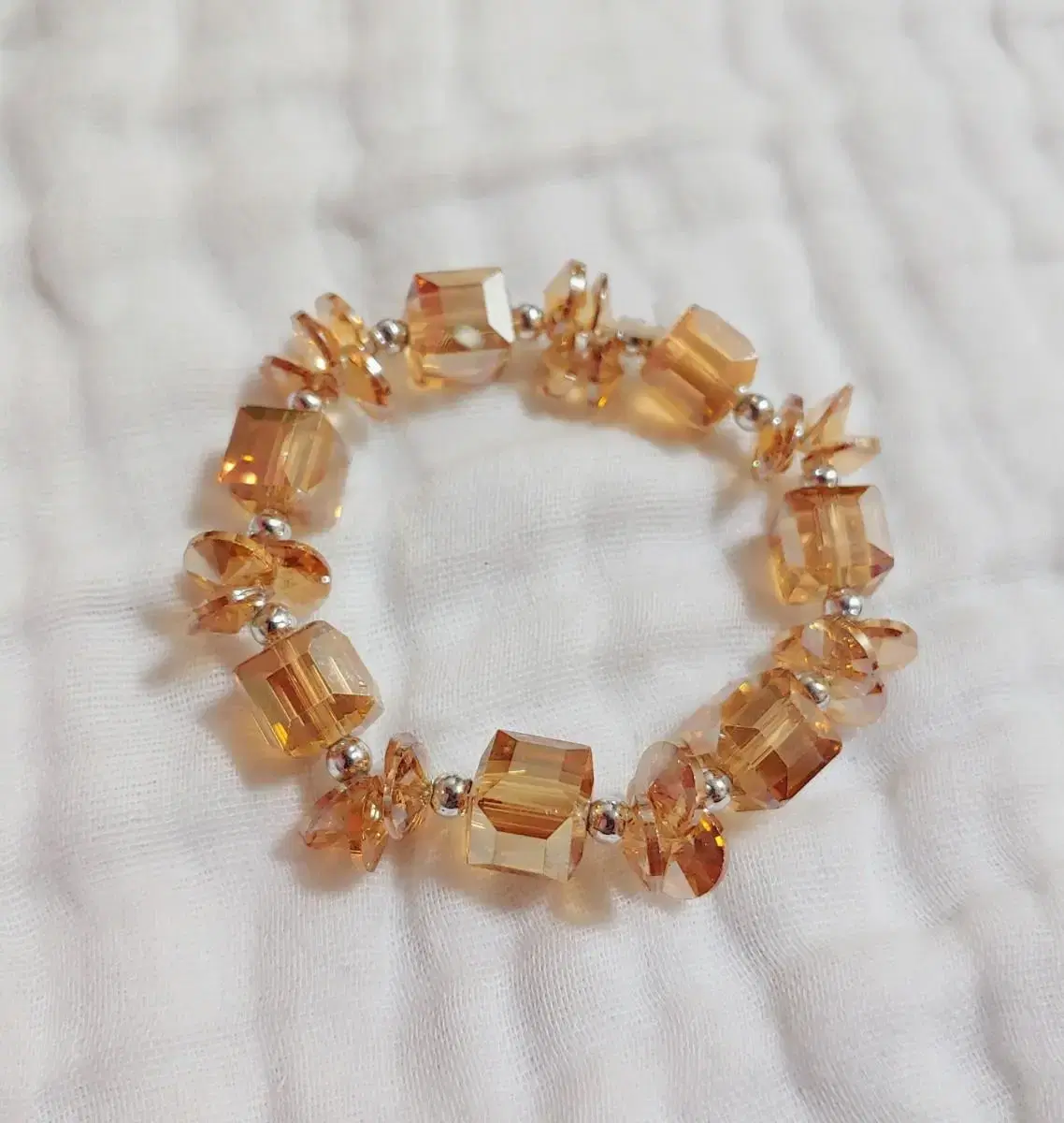 * krystal, a bracelet with a champagne-colored charm