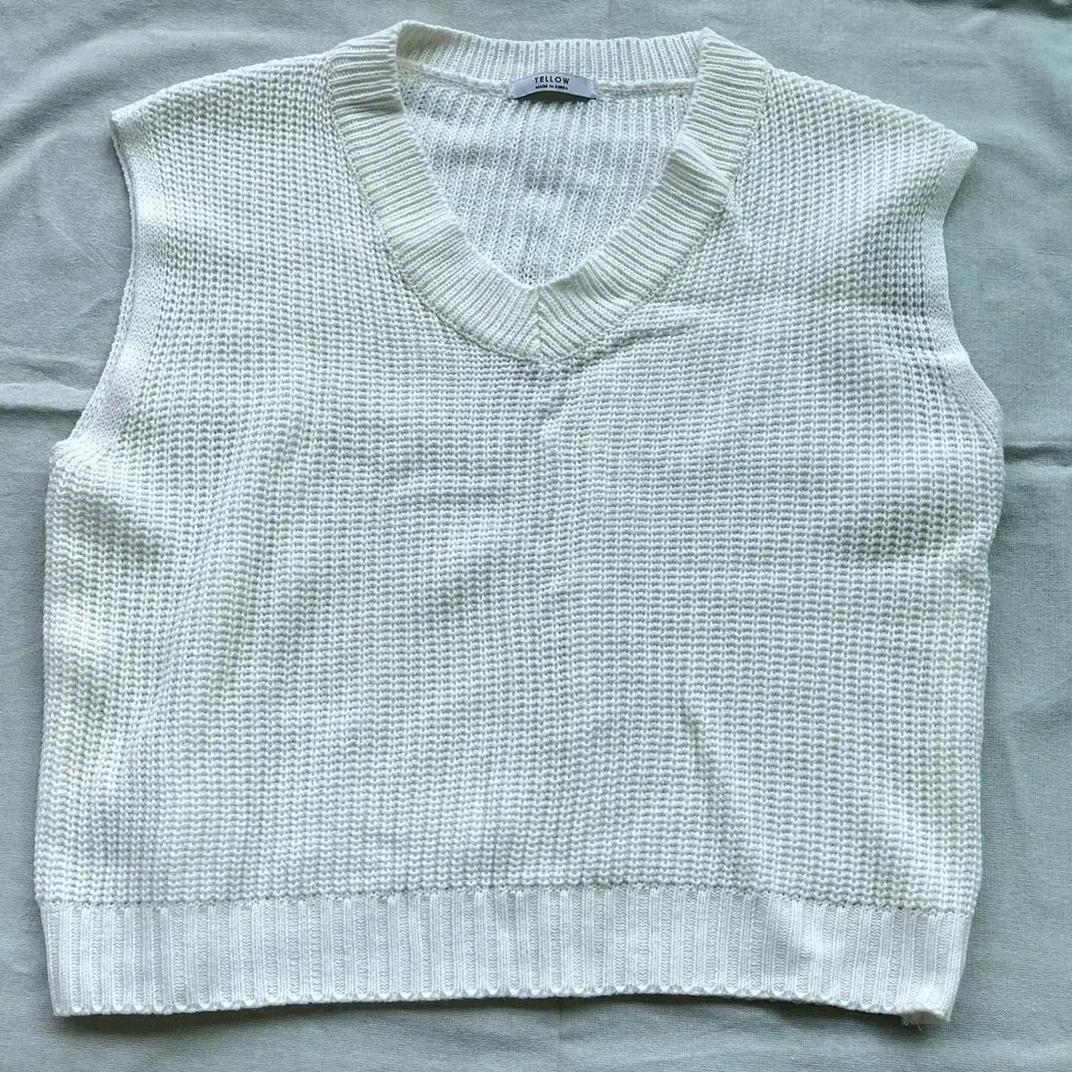 A white knit vest that is easy to layer