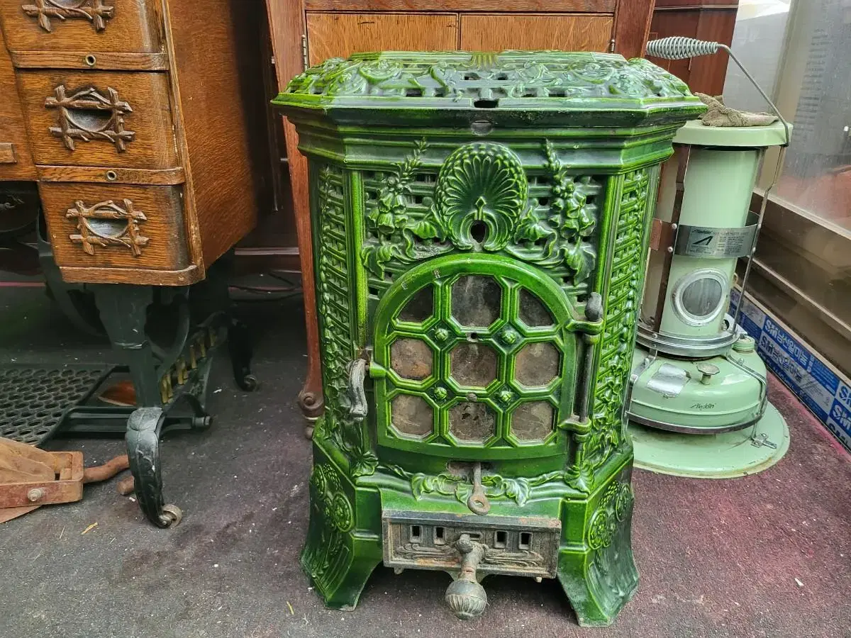 This is an antique French bumpkin & cast iron stove.