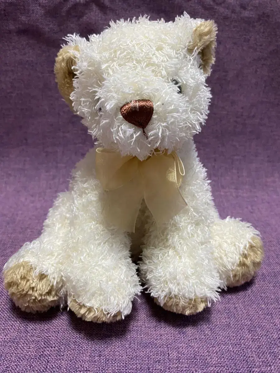 A tactile vintage teddy bear doll