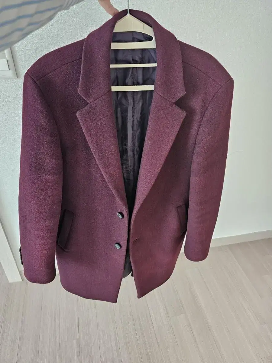 Wine-colored coat, bag included.