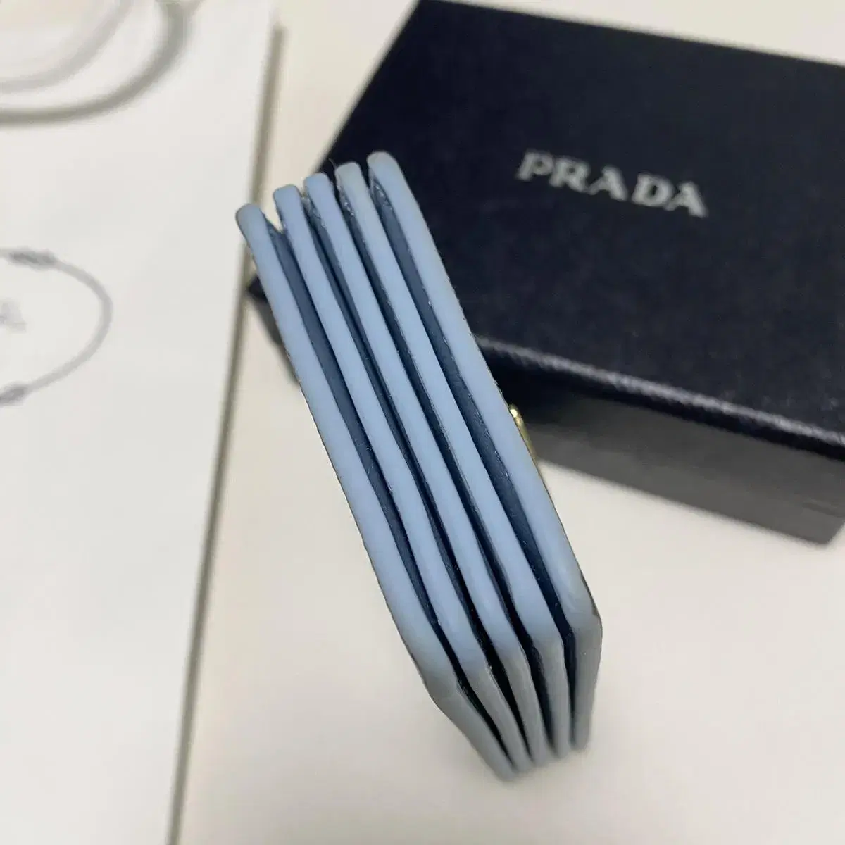 프라다 prada 아코디언 사피아노 가죽 똑딱이 카드지갑 라이트블루