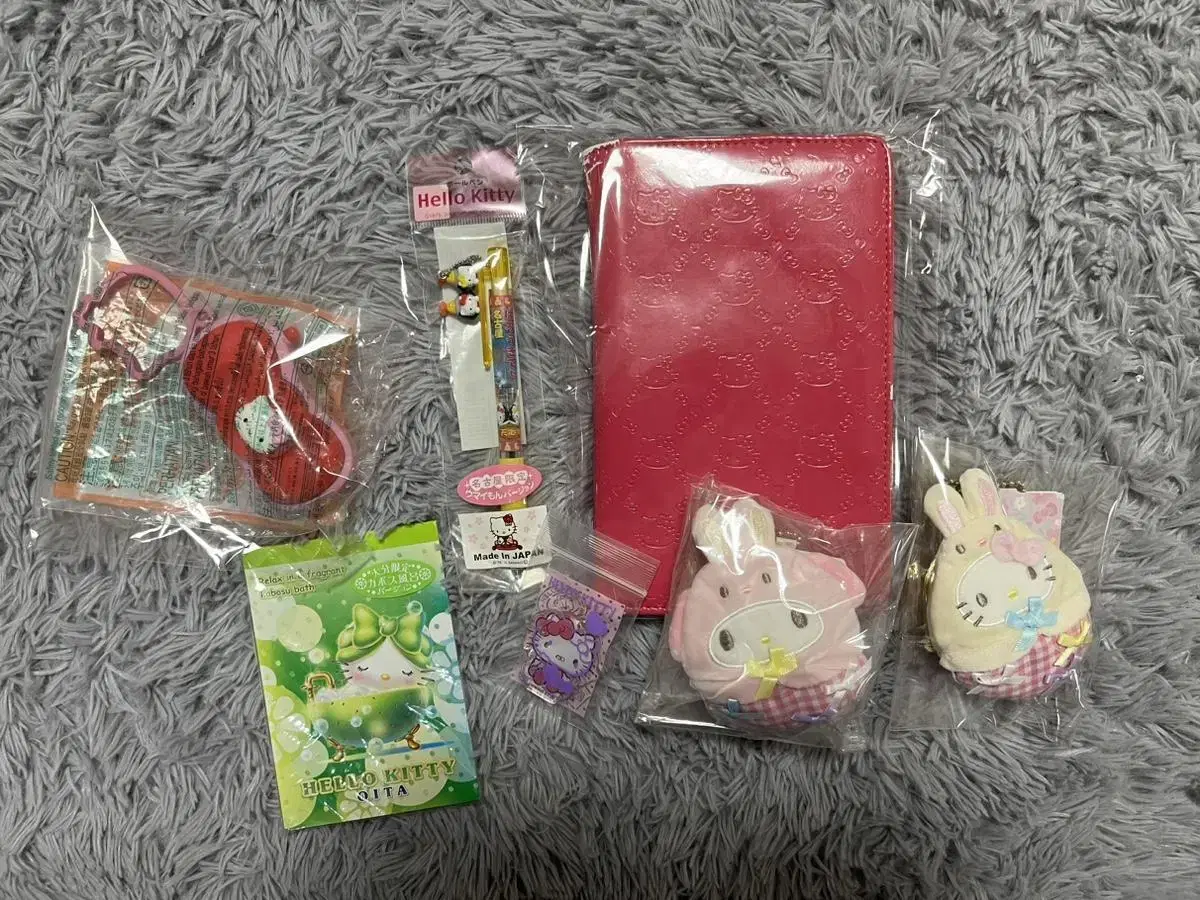 Hello Kitty merchandise, photocards, albums, and ballpoint pens.