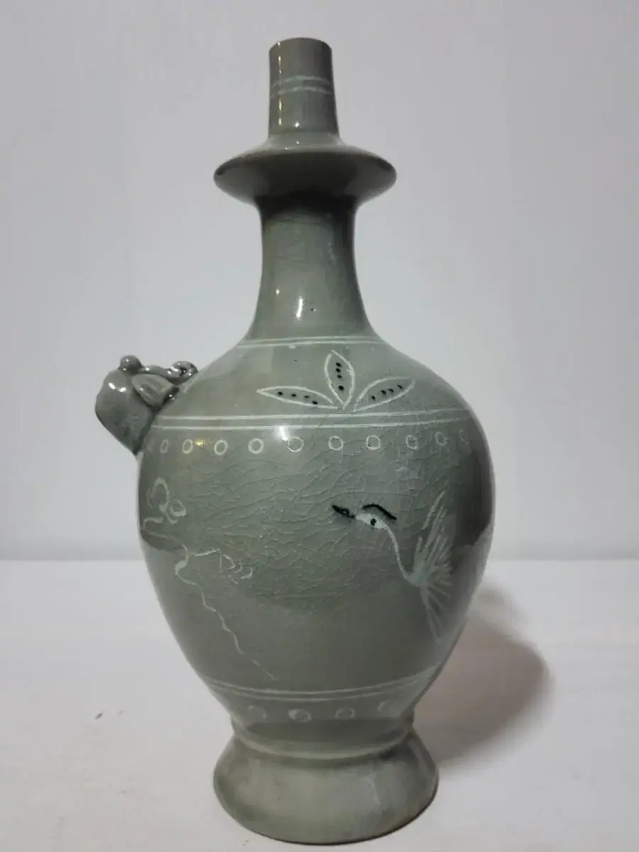 Goryeo celadon with Woonhakmun design on a bottle