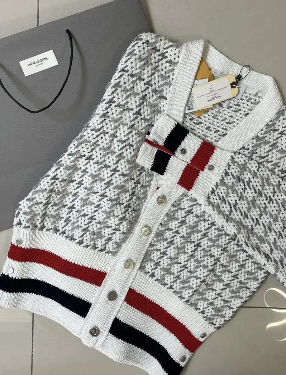 Selling a new Thom Browne cardigan.