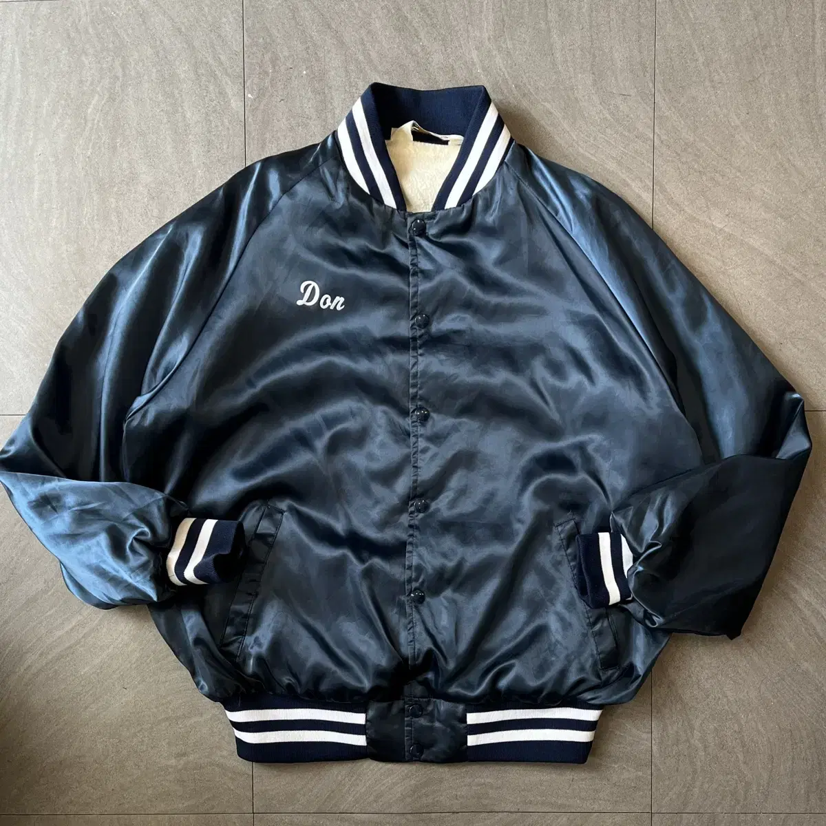 Navy coach jacket produced in the United States in the 1990s