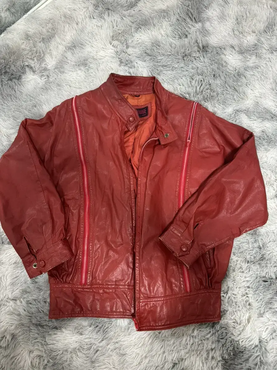 Burgundy red leather jacket with zipper detail