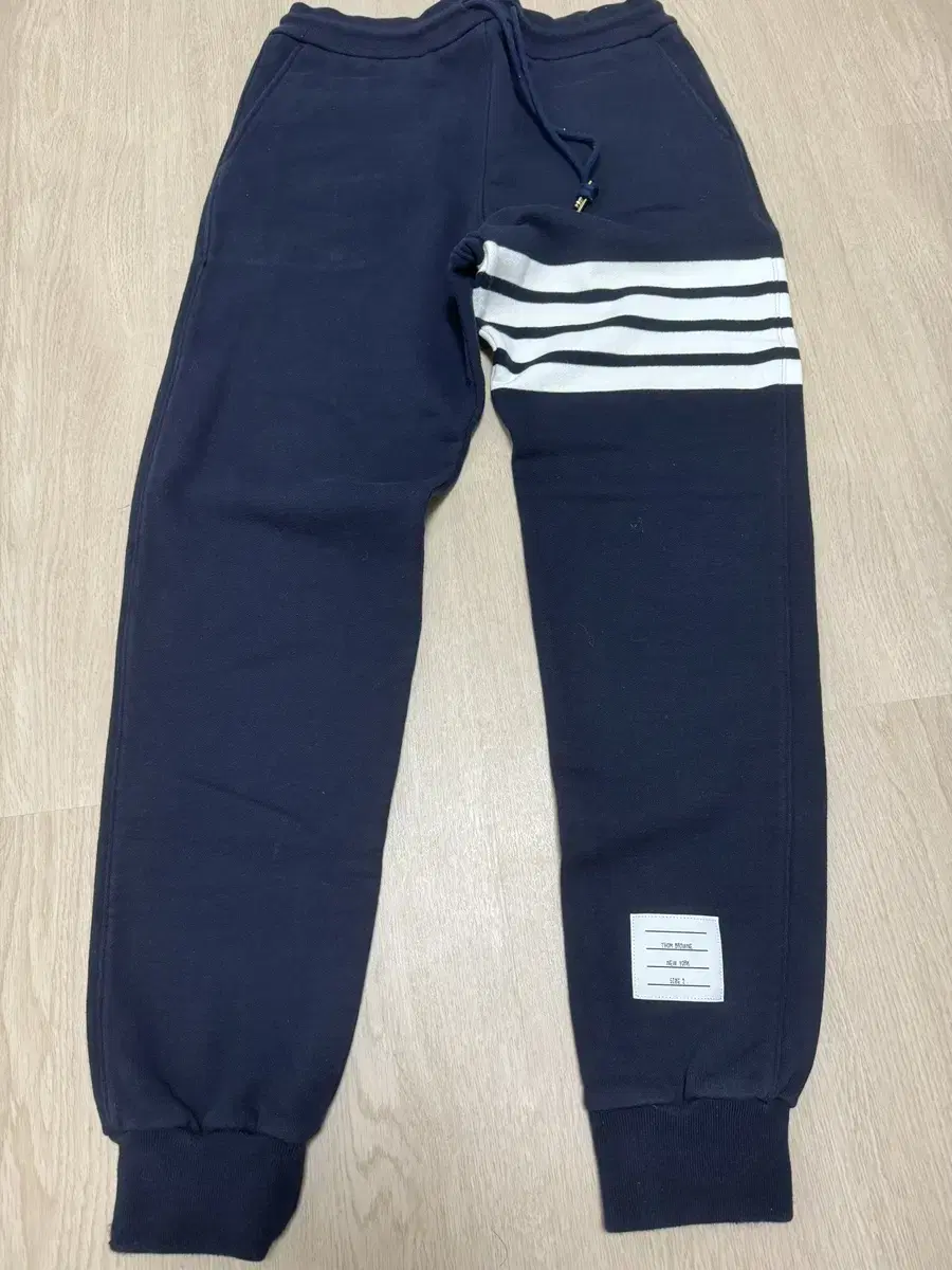 Thom Browne jogger pants for sale~.