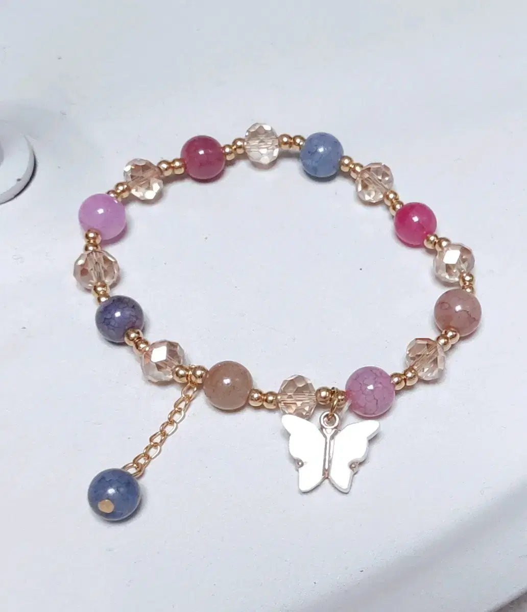 Bracelet with several colored beads and a butterfly