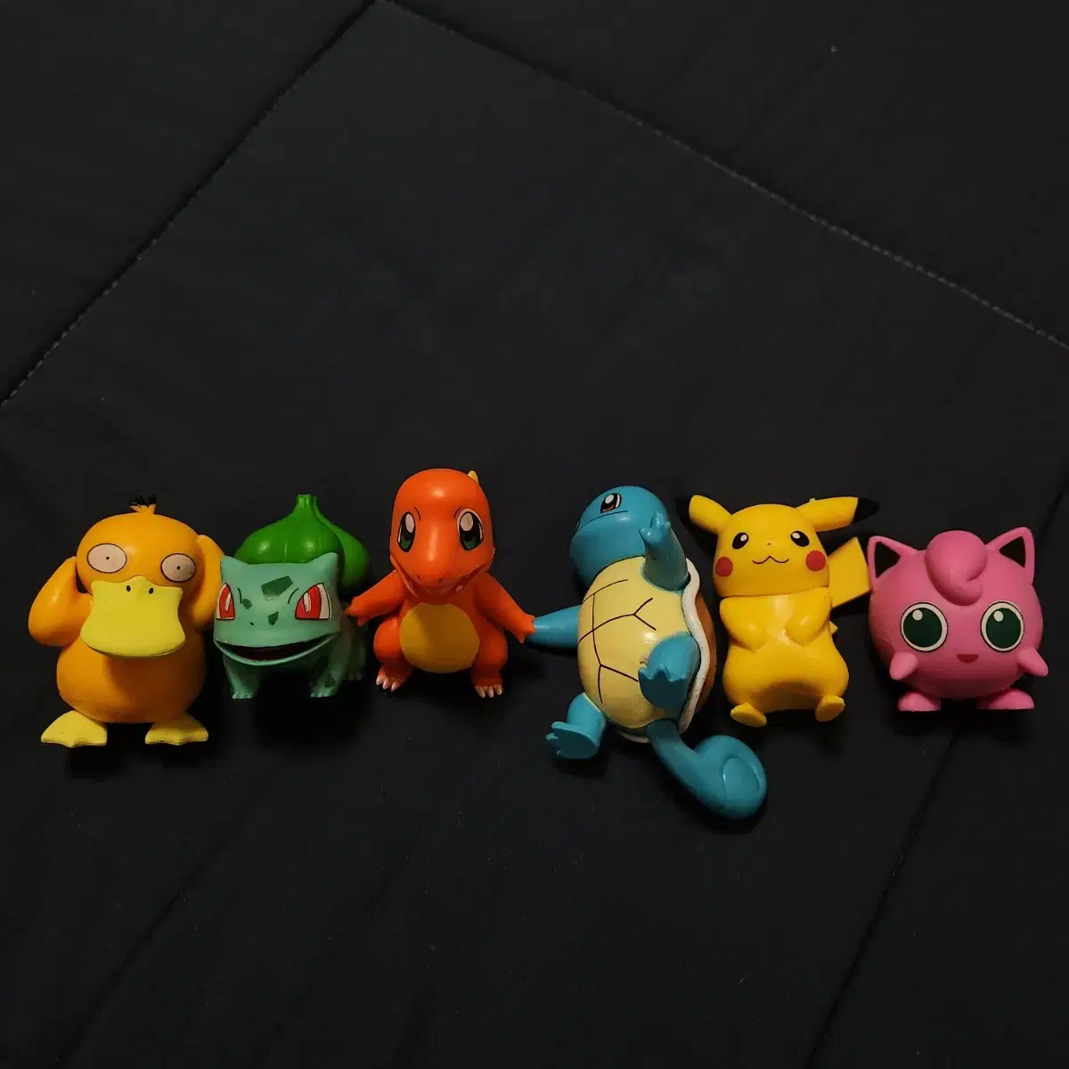 Pokémon figurine toys (Pikachu, Pyree, Twiggy, Charizard, and Puffin,