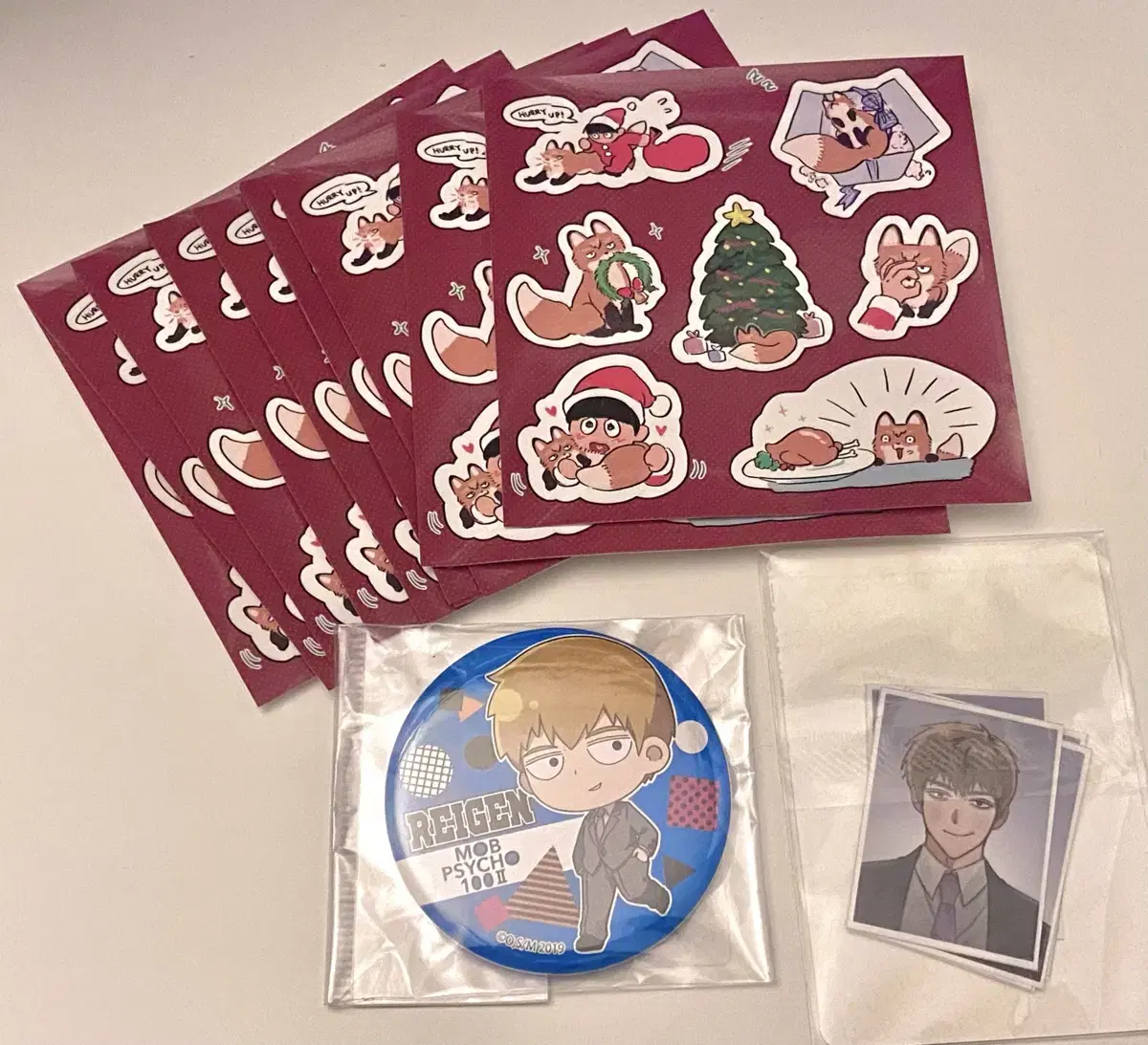 Unofficial Movsaiko photo + sticker and official postcard/badge