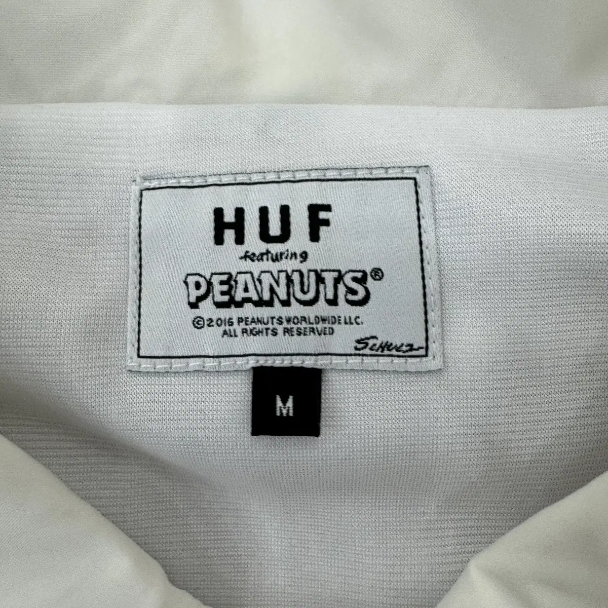 M(100) HUF x PEANUTS 콜라보 화이트 코치 자켓