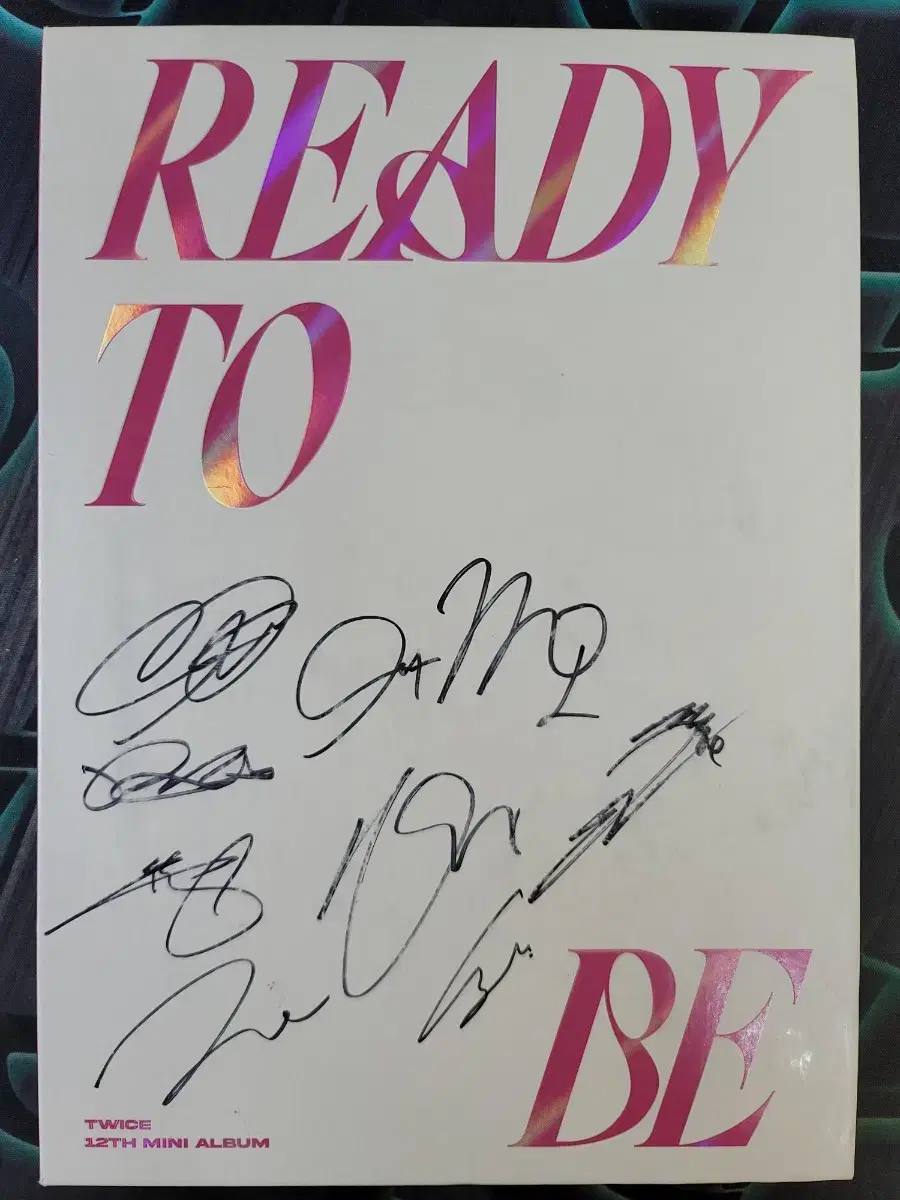 An album autographed by all non-selling members of TWICE.