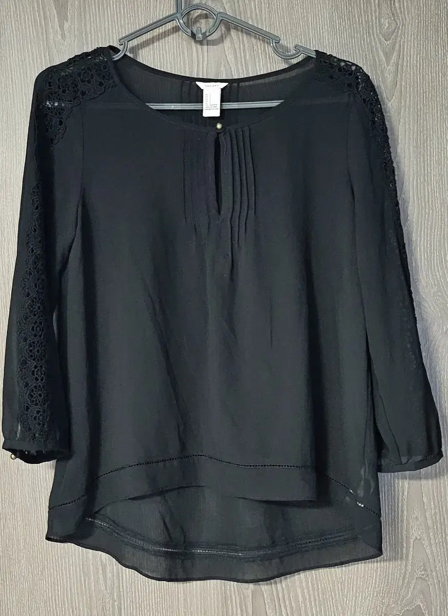 See-through seven-quarter-length black blouse