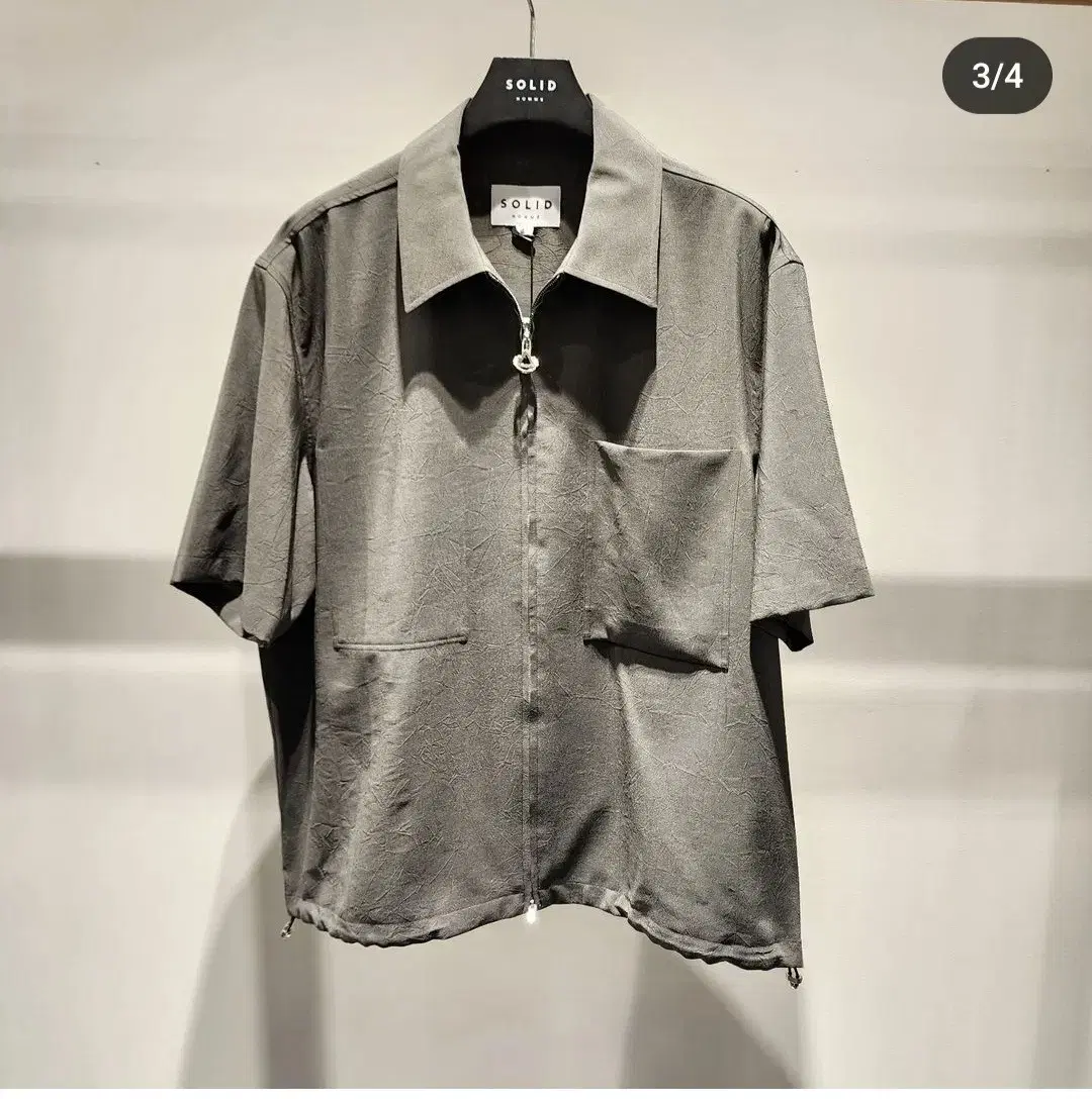 I am selling a Solid Homme 23SS crinkle gray short sleeve shirt in size 46.