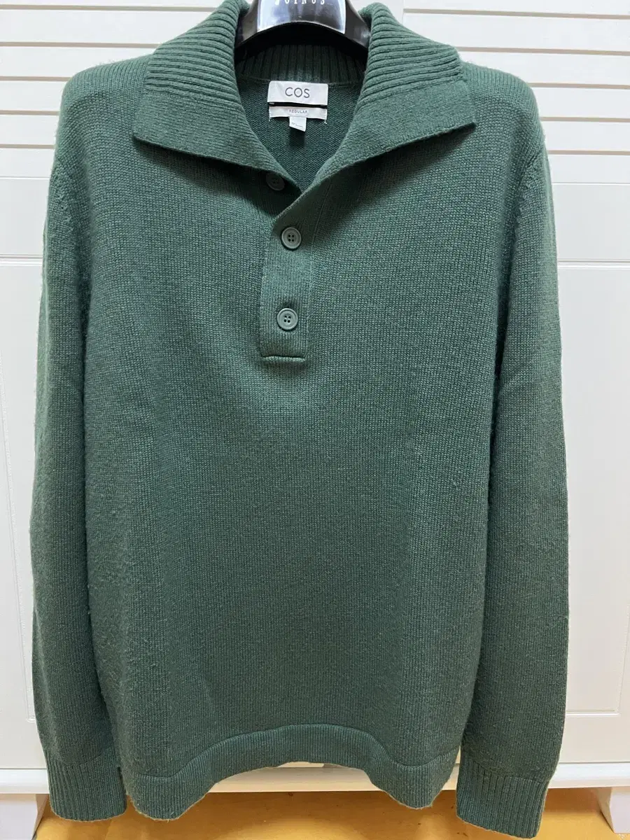 We're selling a green knit in cos, size L.