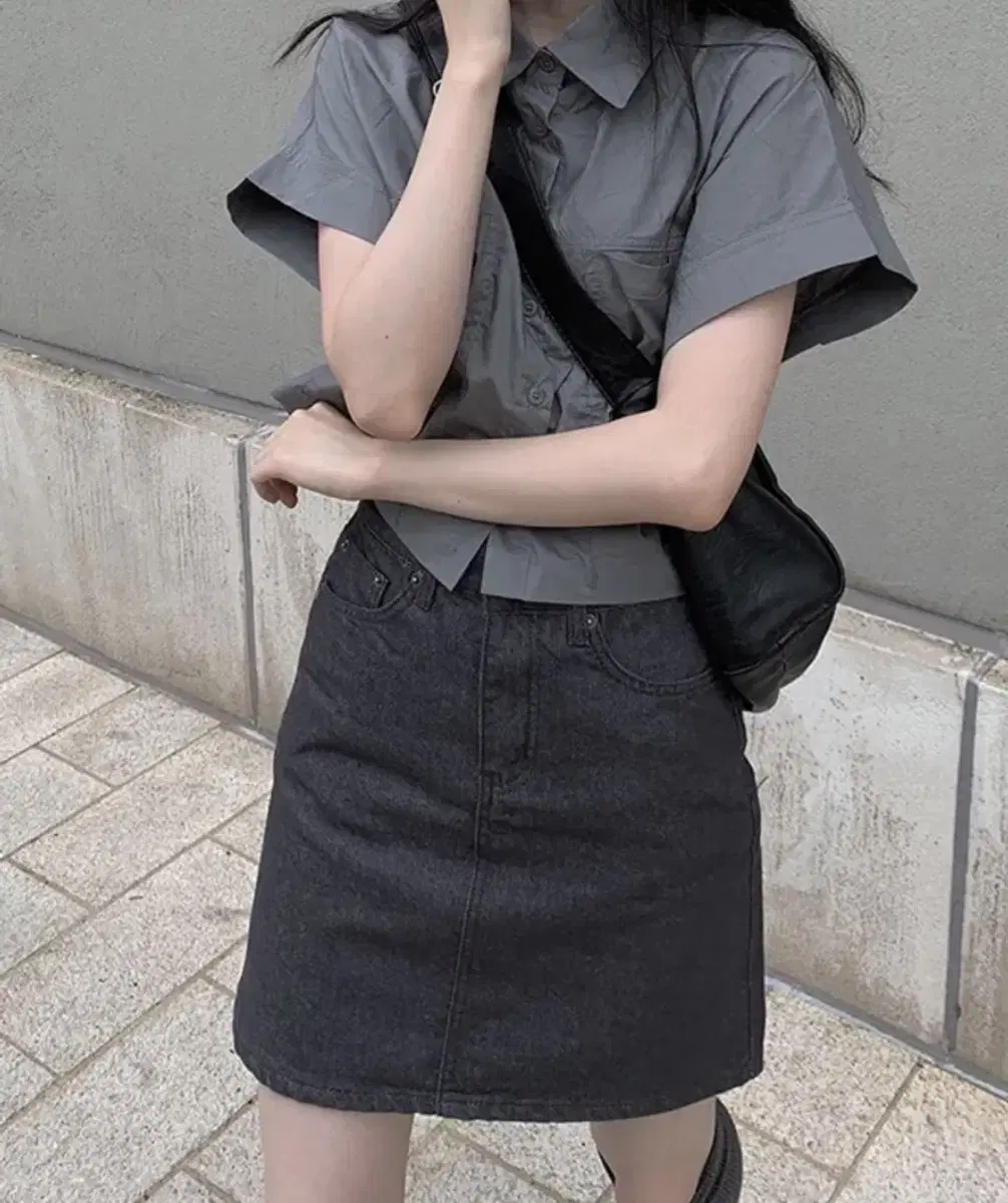 I'm selling a gray shirt and black-blue skirt set.