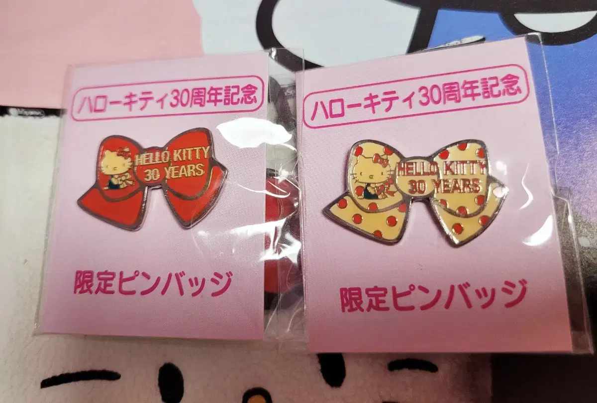 A set of two limited edition pin badges celebrating the 30th anniversary of the classic Hello Kitty.