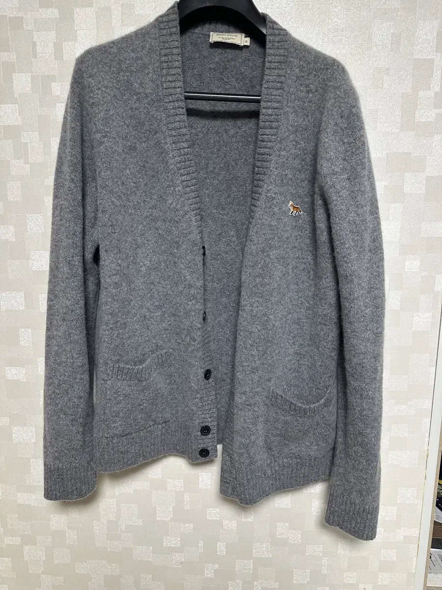 I'm selling a Maison Kitsune lambswool cardigan in size XL.