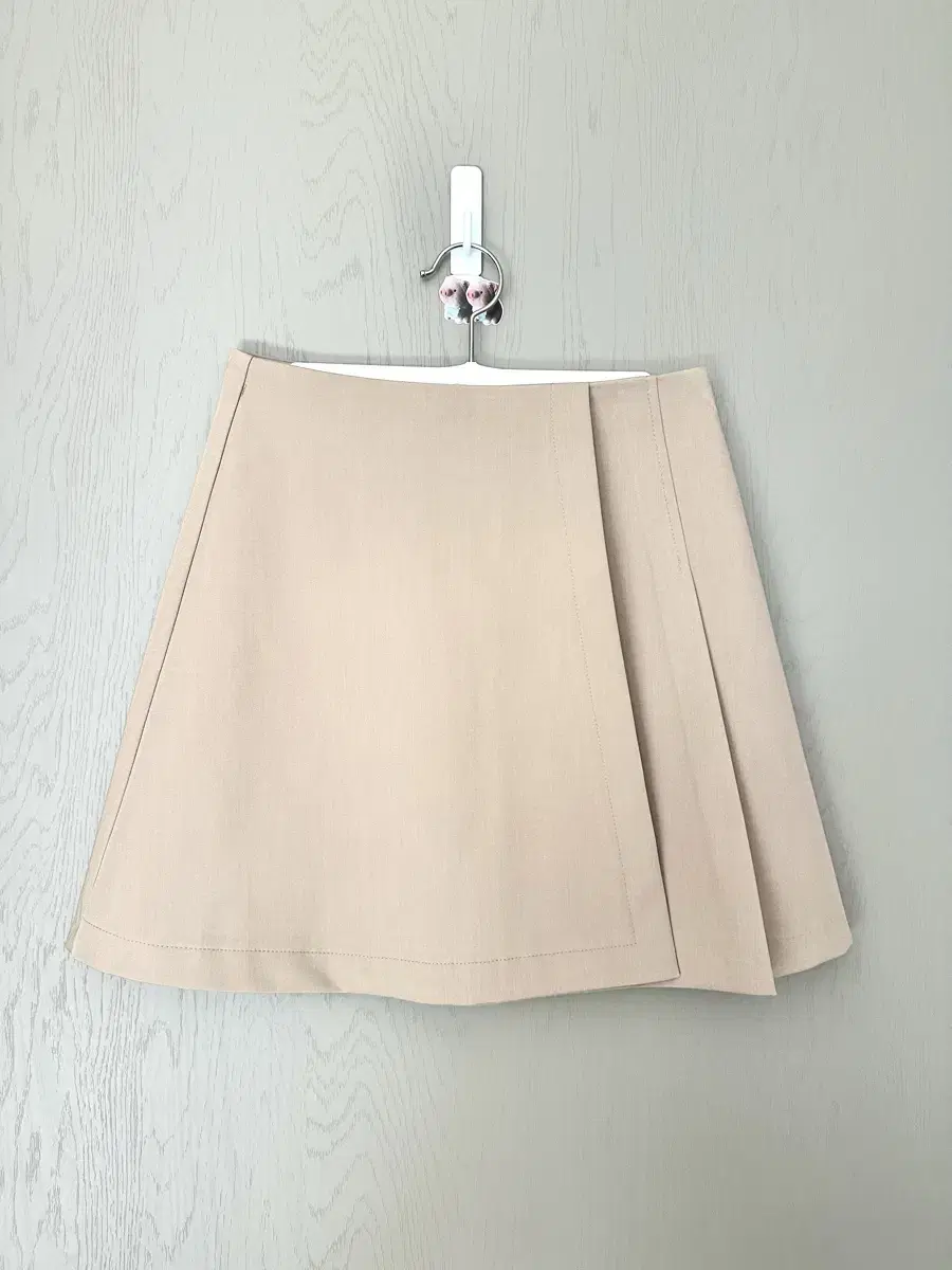 Beige pleated a-line miniskirt