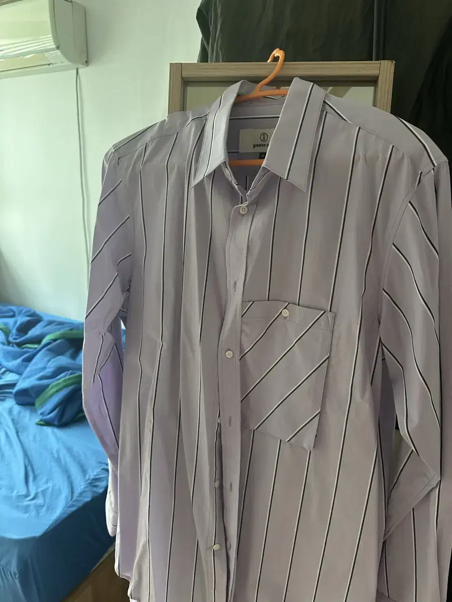 I'm selling a purple striped shirt, size S, from Earth's A Go.