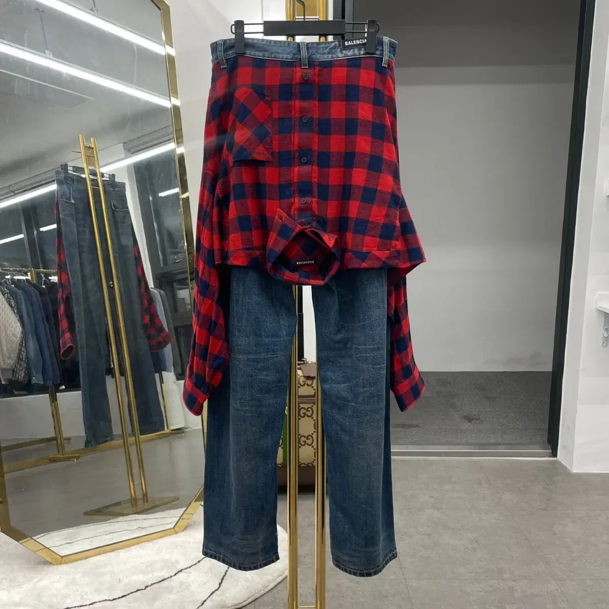 Balenciaga shirt layered with denim pants