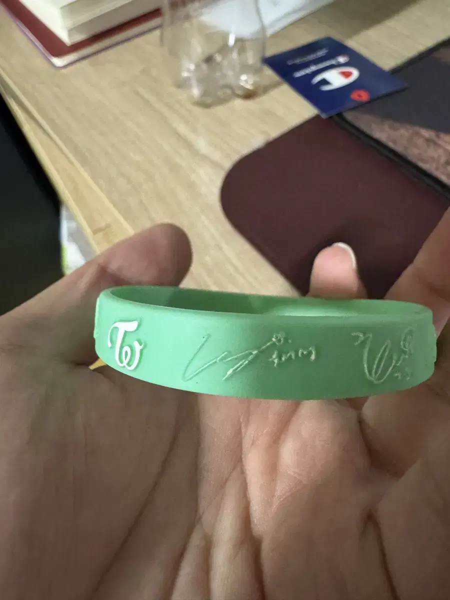 A silicone bracelet signed by all TWICE members.