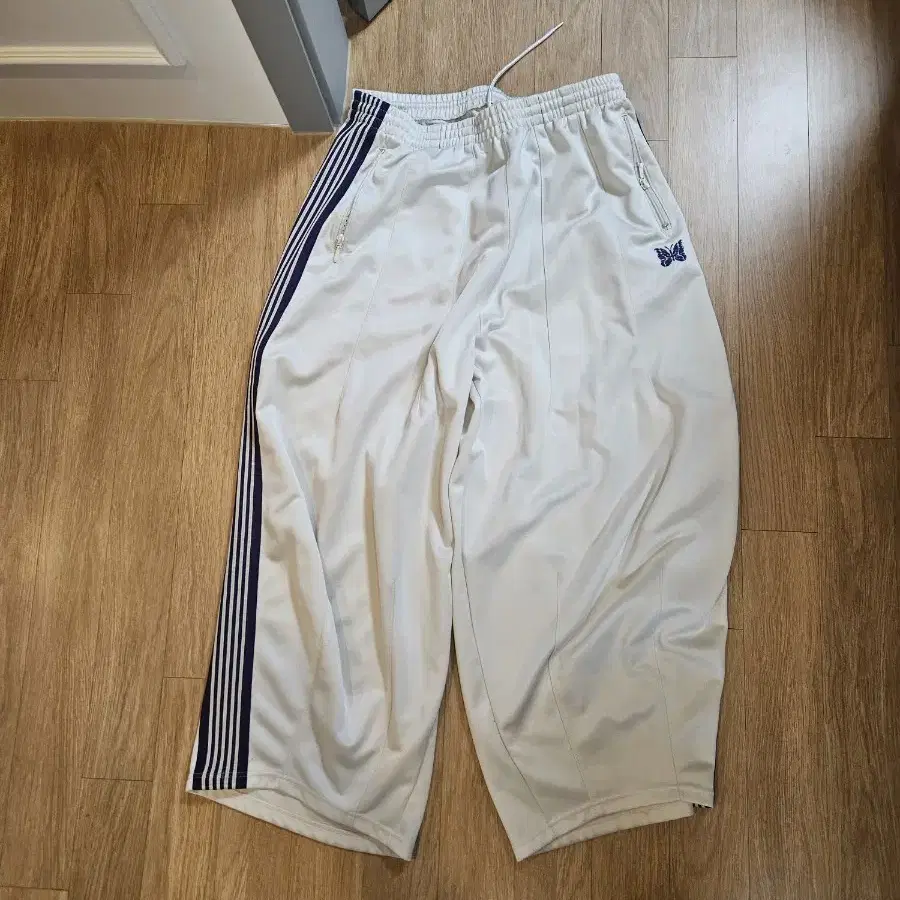 needles track pants ice white