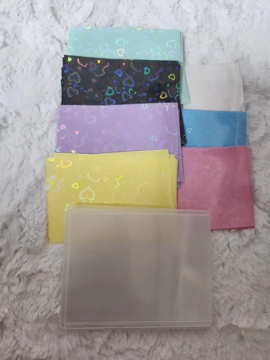 I'm selling 5 of each of the 7 colored heart sleeves + 5 of the large toploader!