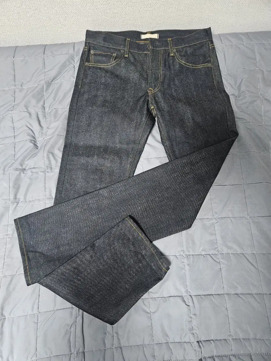 I'm selling a pair of Uniqlo raw edge rigid denim jeans 31 inches new.