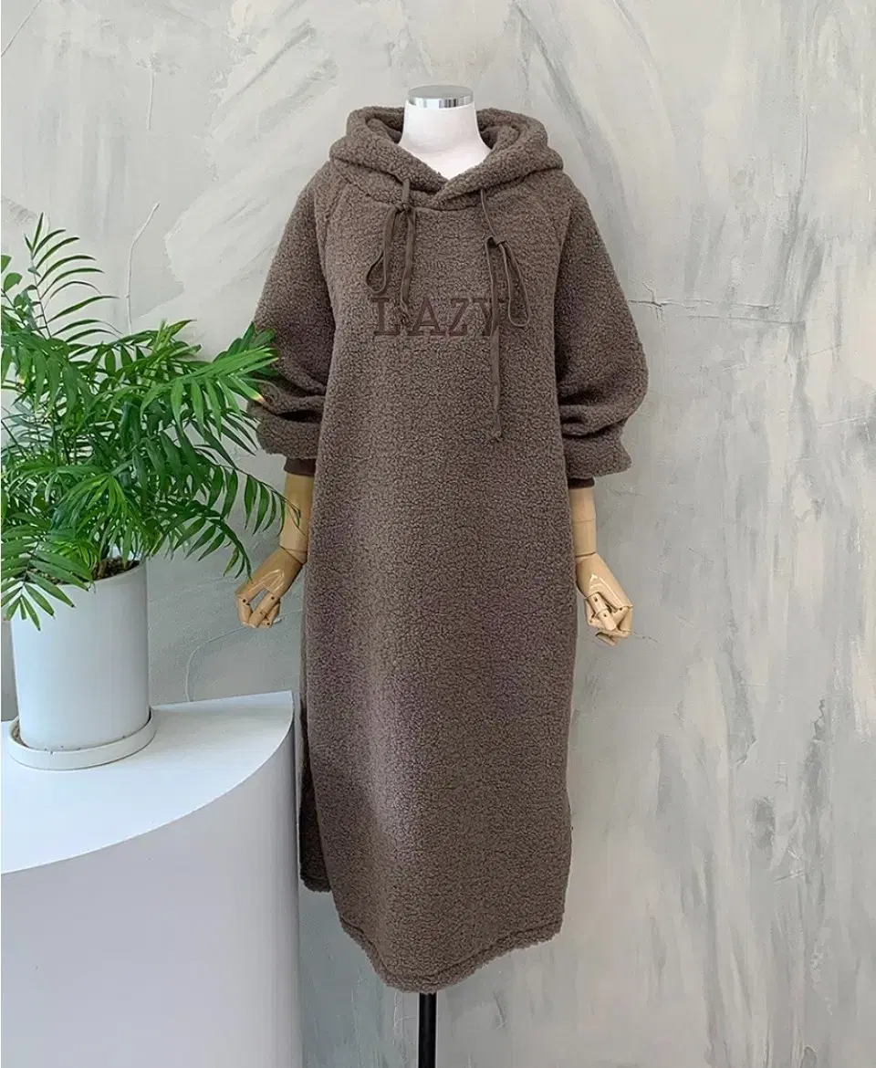 "loose-fitting hooded peek-a-boo onepiece"