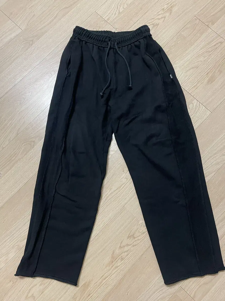 One-of-a-kind black reverse-cut pants