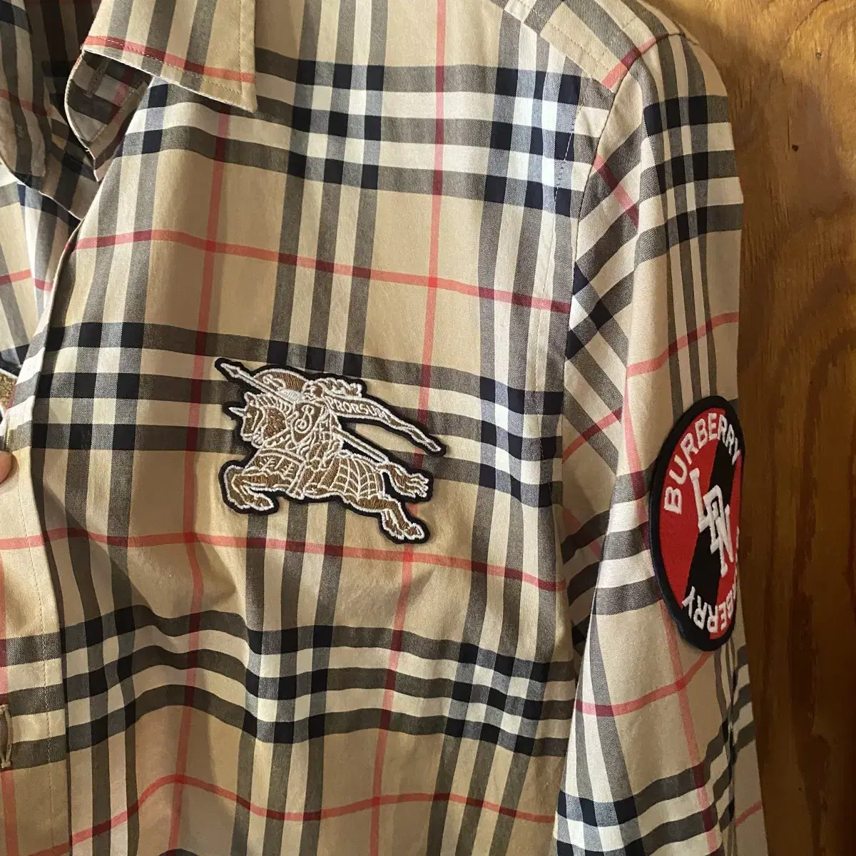 Burberry patches nova and checked shirts sell.