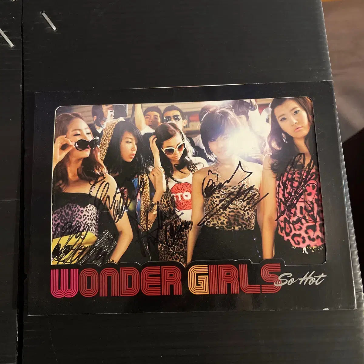 An autographed album signed by all of the Wonder Girls.