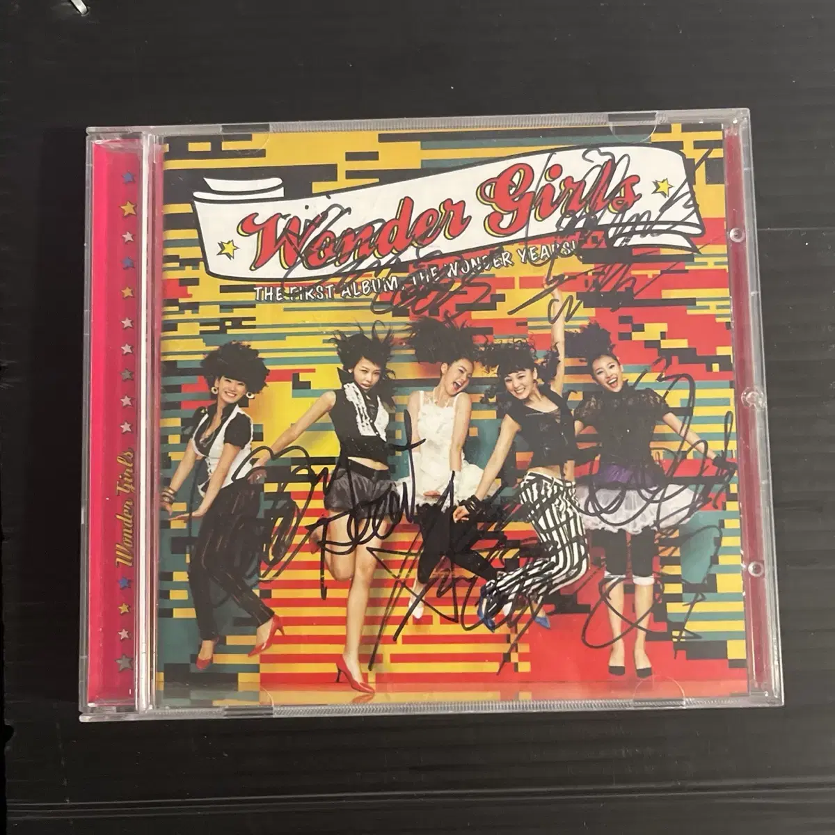 An autographed CD album signed by all of the WonderGirls, Vol. 1.