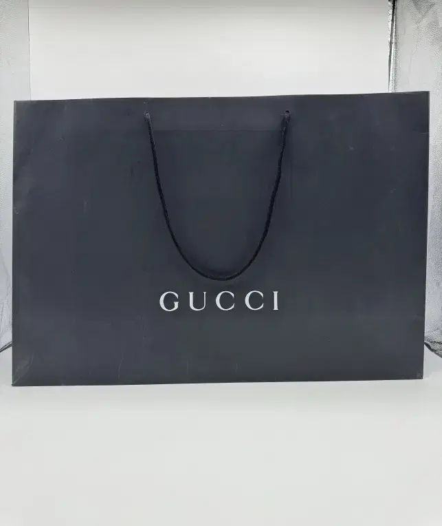 Luxury shopping bags (Gucci, Philipp Plein, Onitsuka Tiger Vivienne Westwood)