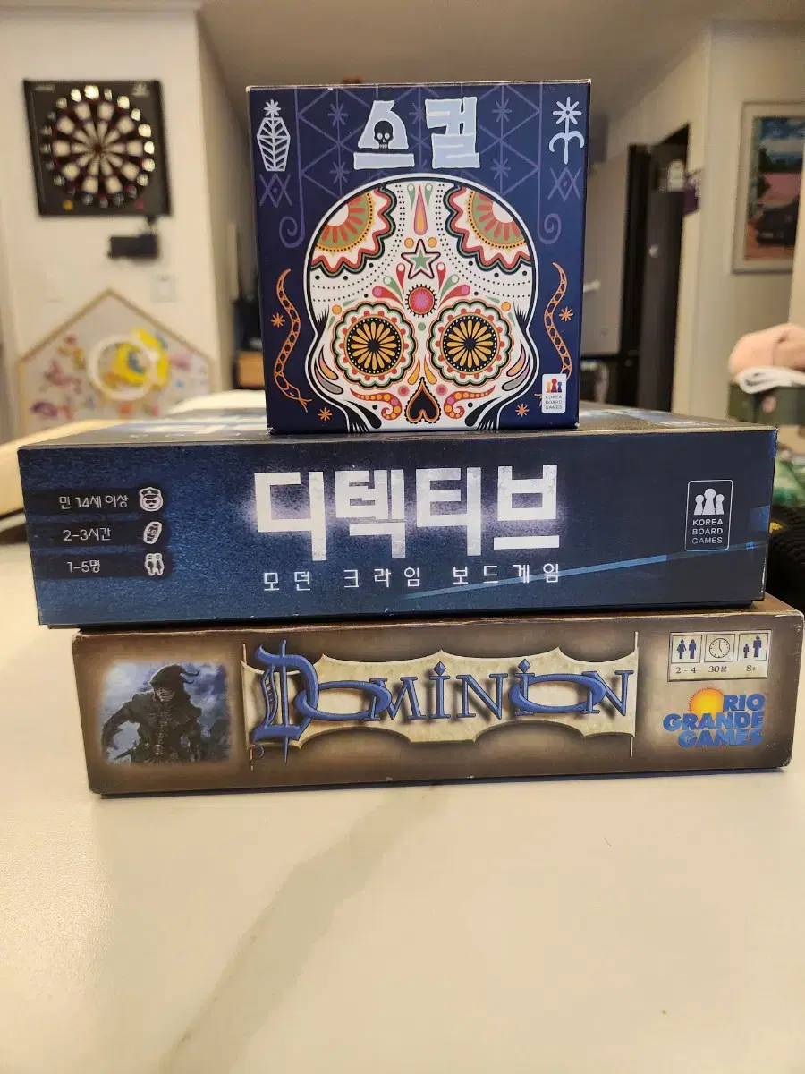 Sells Skull, 13 Clues, Dominion, and Detective board games.