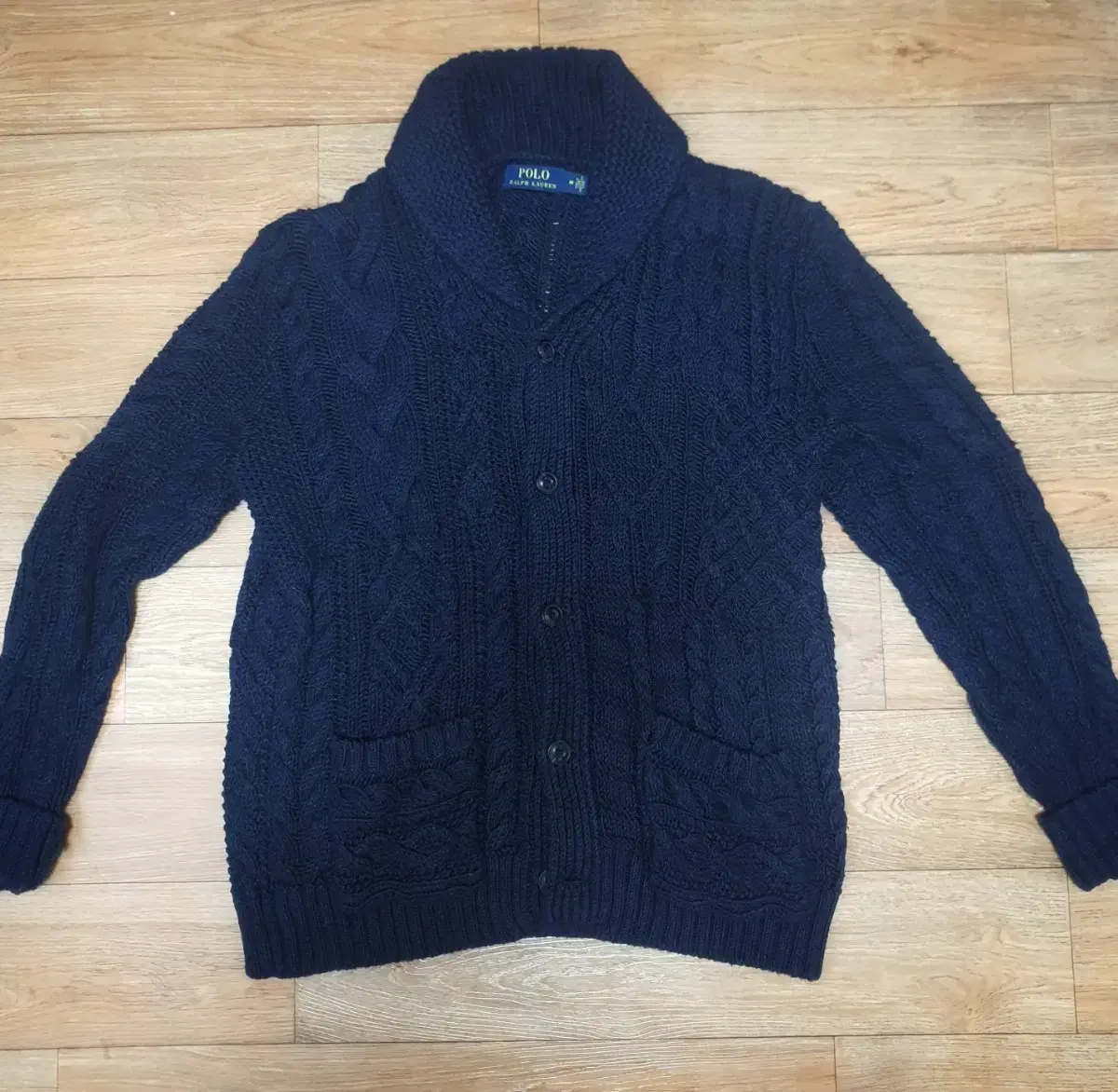 Polo Ralph Lauren's patentwork pretzel shawl kara cardigan is for sale.