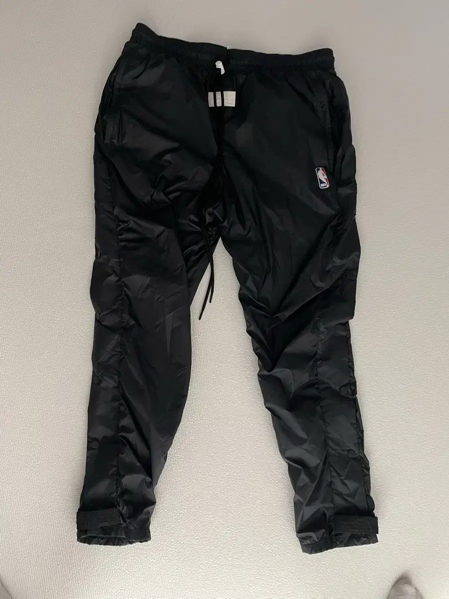 [L] First edition of Nike P.O.'s nylon side-button pants.