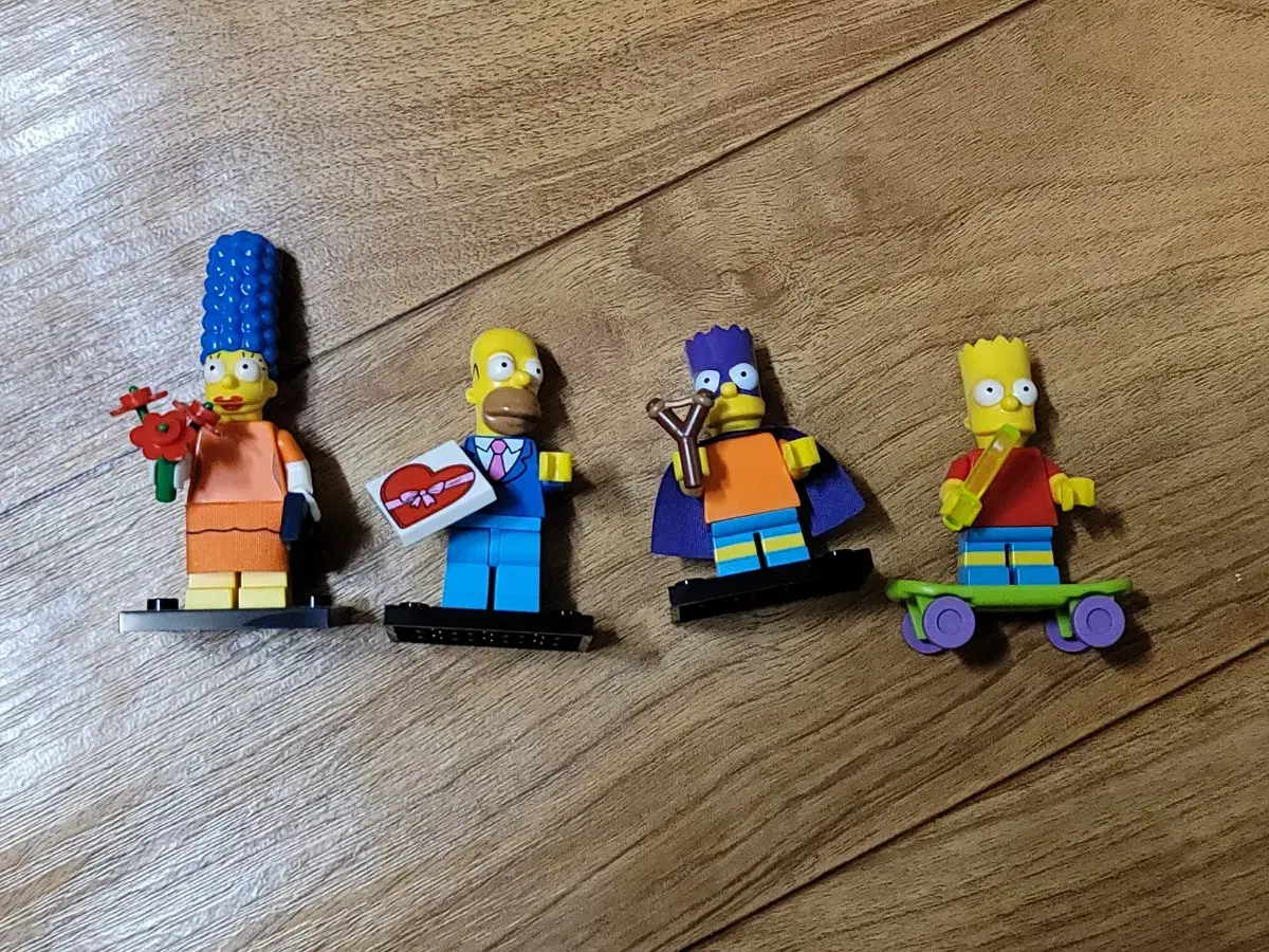 Four genuine LEGO minifigure Simpsons for sale.