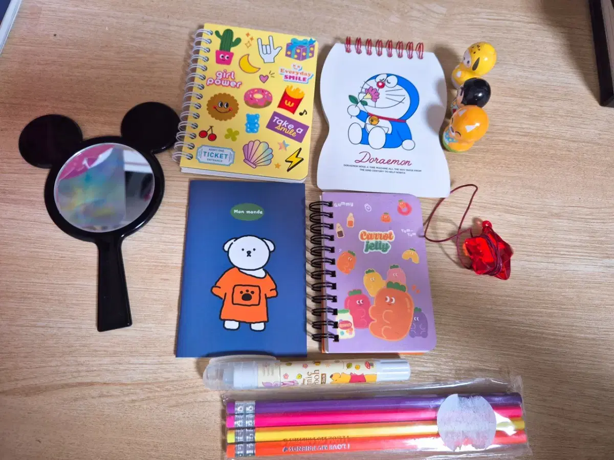 4 notebooks, 4 sets of pencils, 3 owls, Minnie Mouse mirror, Pooh Pool, star