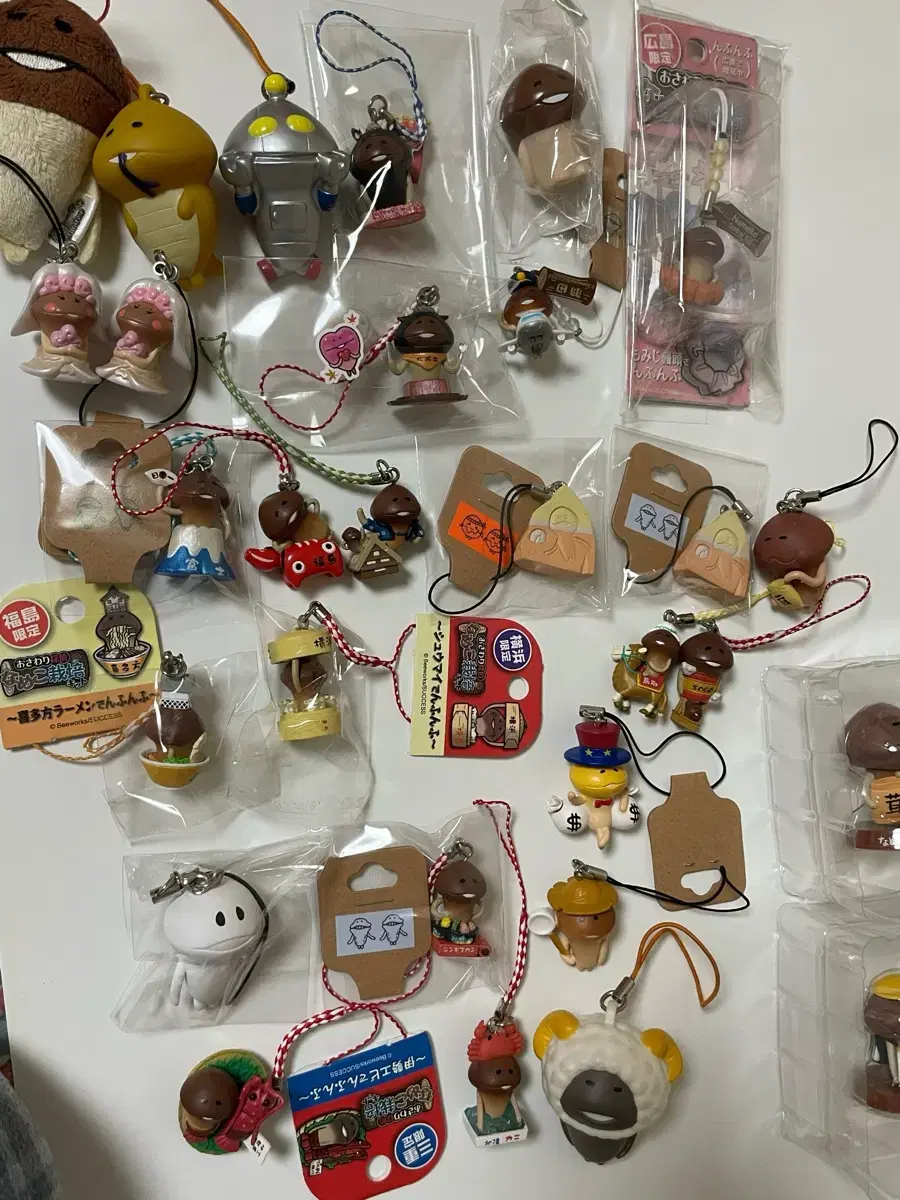 Sells Nameko straps, gachas, keyrings, and figures (plus 3 more in the back)