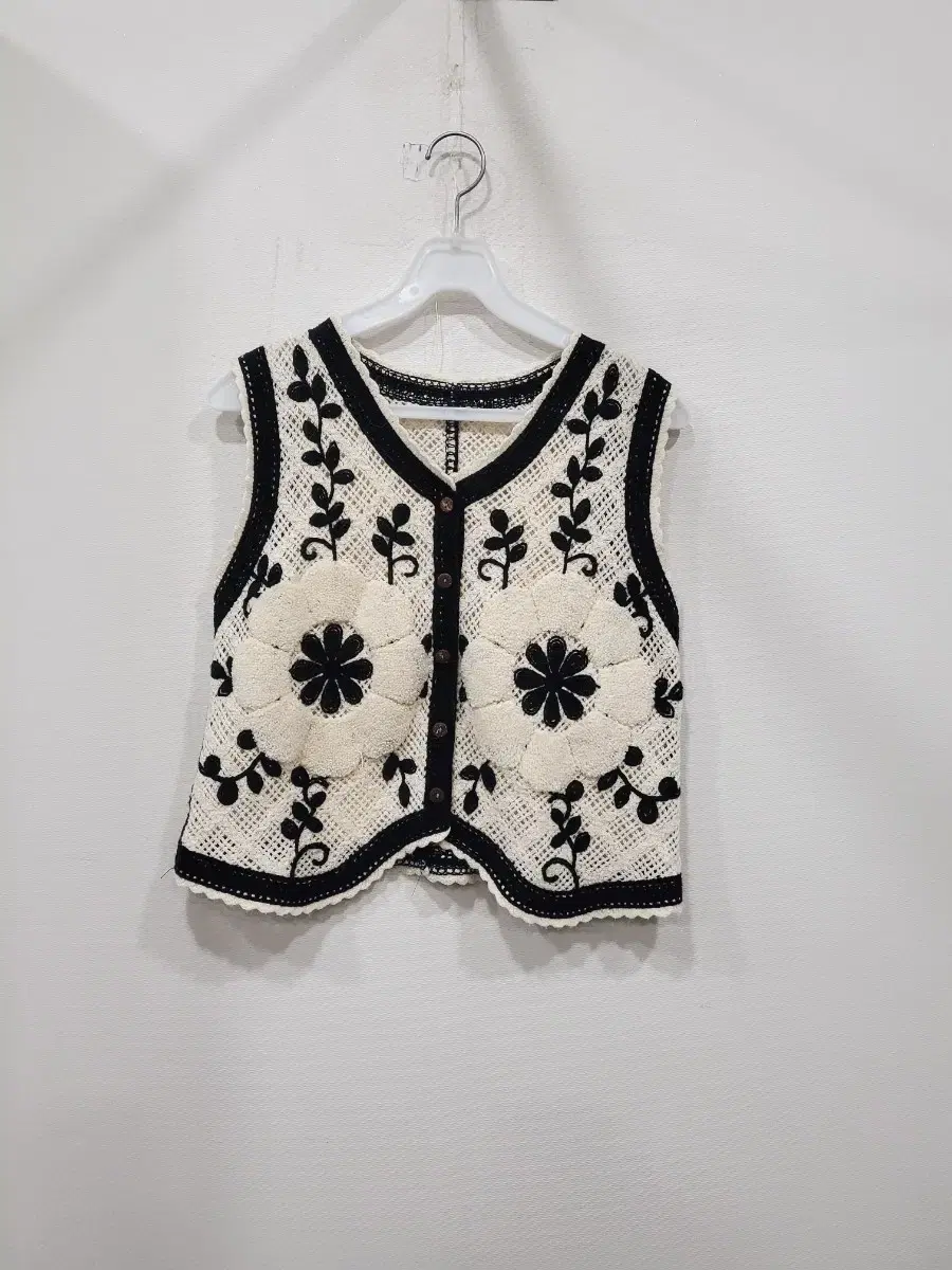 Knitted vest with crocheted flowers