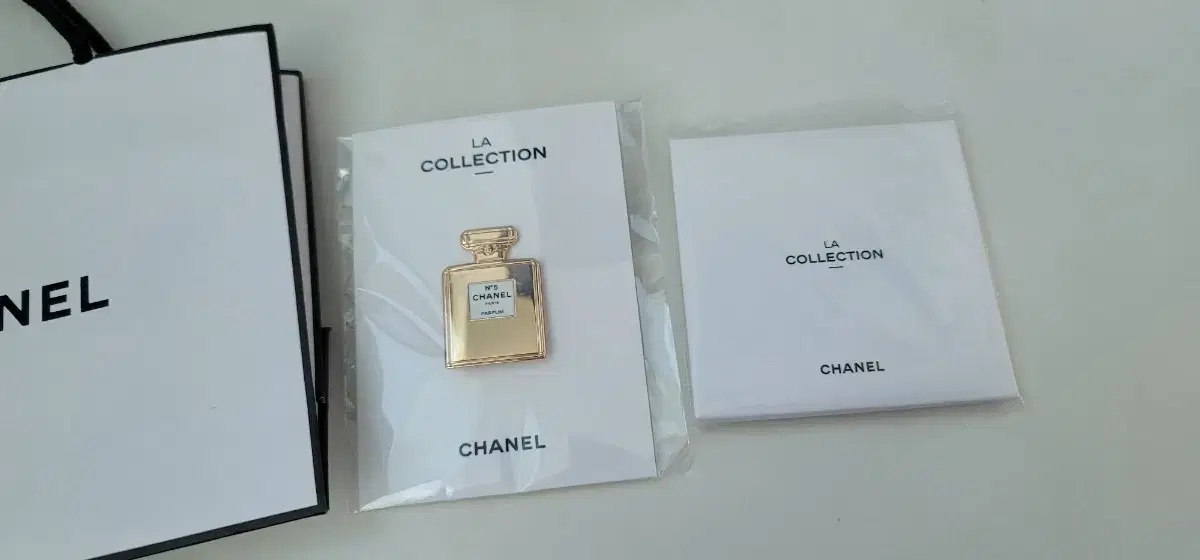 (Unsealed) Chanel No. 5 Badge + Camellia key Chain