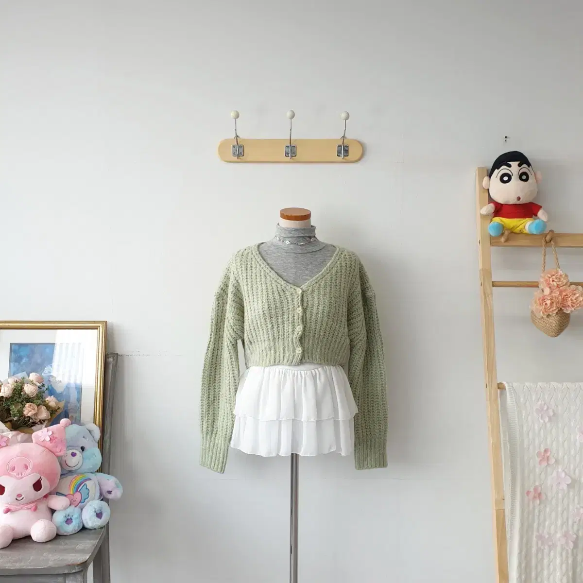 CLO's pastel green cozy cardigan from a vintage clothing store